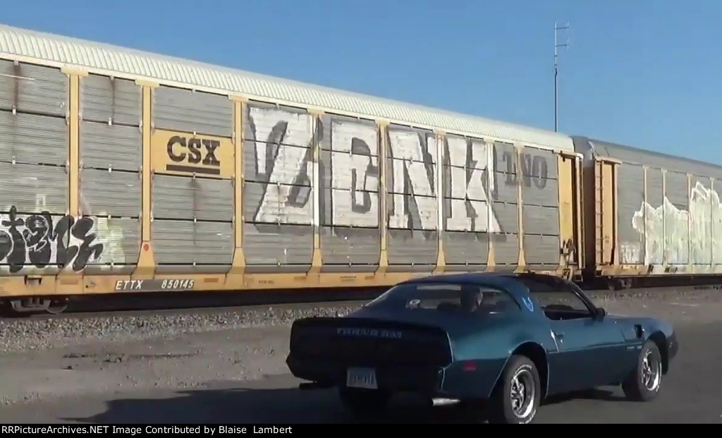 Pontiac Trans Am passes NS autorack train 